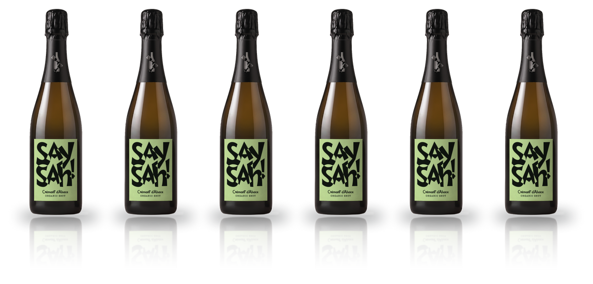 Six bottles of Saysah Organic Brut standing in a row with space between them