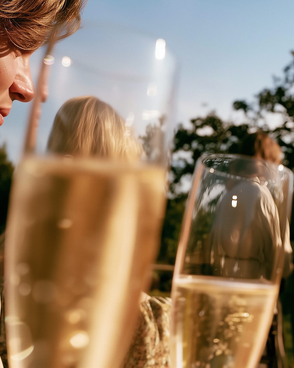 Friends in a garden with glasses of sparkling wine